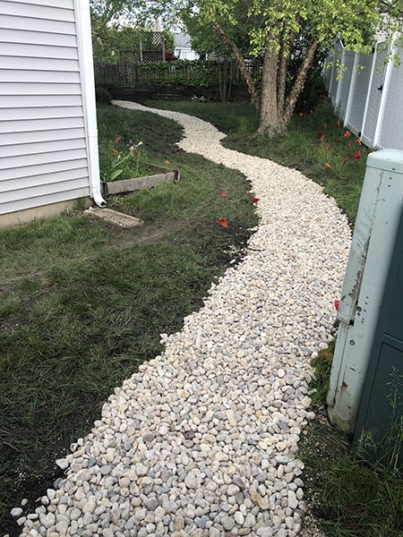 Stepping stone walkway through a professionally landscaped garden in Harvard IL