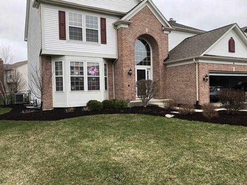 Landscape design featuring ornamental grasses and stone edging