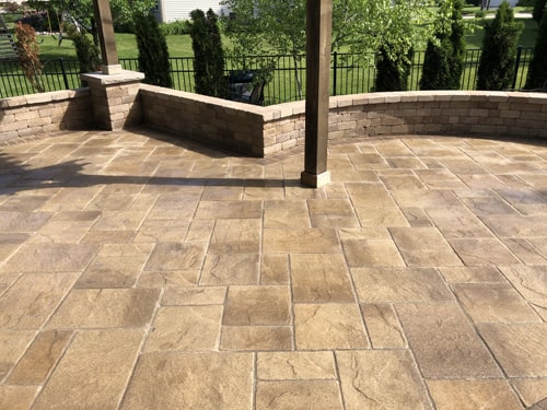 Modern backyard layout with artificial turf and patio stones