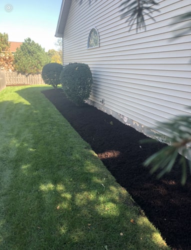 Front-yard makeover by Plant Garden Landscaping in Harvard IL with fresh sod and flower beds
