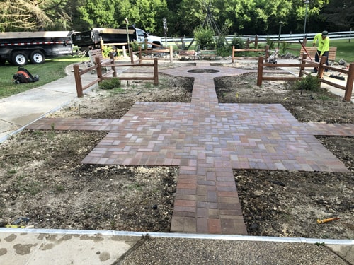 lassic brick paver path connecting patio to garden area