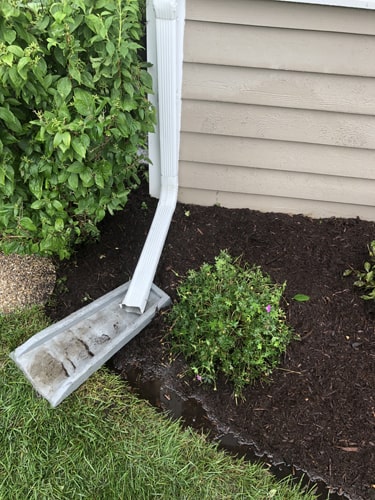 Healthy front yard lawn after professional fertilizing and mowing service