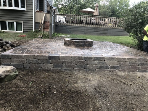 Finished fire pit made of paver bricks, ready for entertaining guests