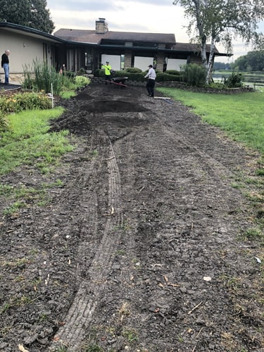 Fresh sod being laid in a residential front yard by Plant Garden Landscaping